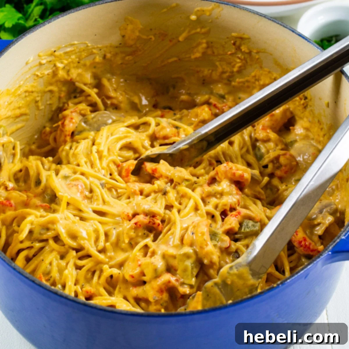 Rich and creamy Crawfish Tetrazzini served generously in a large Dutch oven, garnished with fresh parsley and ready to be enjoyed.