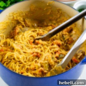 A vibrant and appetizing close-up of Crawfish Tetrazzini with fresh parsley garnish in a serving bowl.