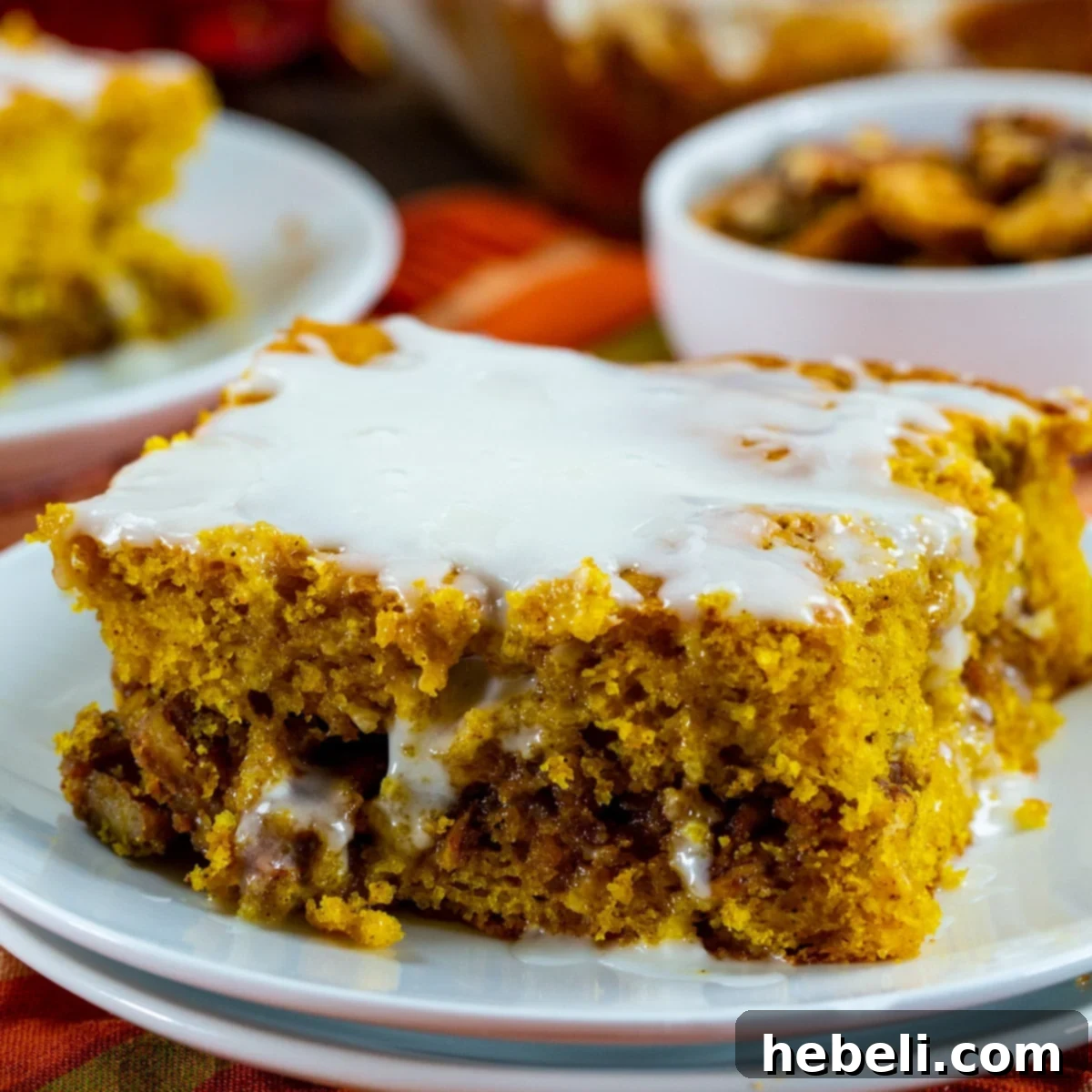Honey Glazed Pumpkin Swirl Cake 2 A generous slice of Pumpkin Honey Bun Cake on a decorative plate, ready to be enjoyed.