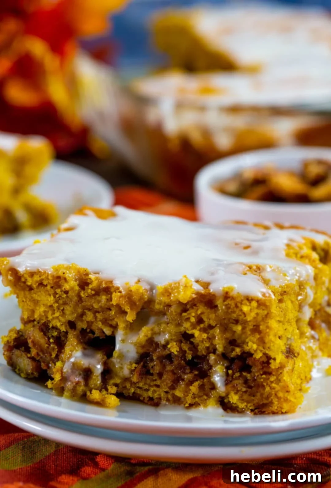 Honey Glazed Pumpkin Swirl Cake 6 A perfectly portioned piece of Pumpkin Honey Bun Cake on a small white plate.
