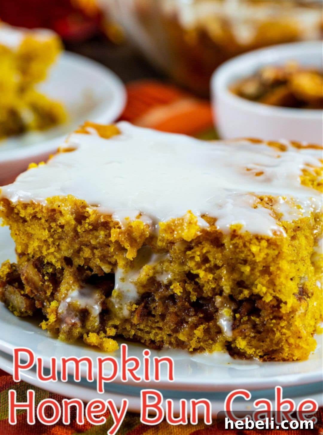 Honey Glazed Pumpkin Swirl Cake 7 A detailed close-up shot of a slice of Pumpkin Honey Bun Cake, highlighting its moist interior and swirled filling.