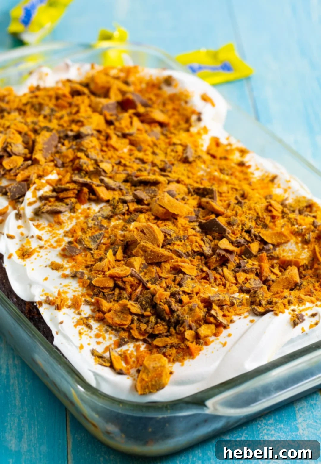 Whole Butterfinger Poke Cake in 9x13-inch baking dish.