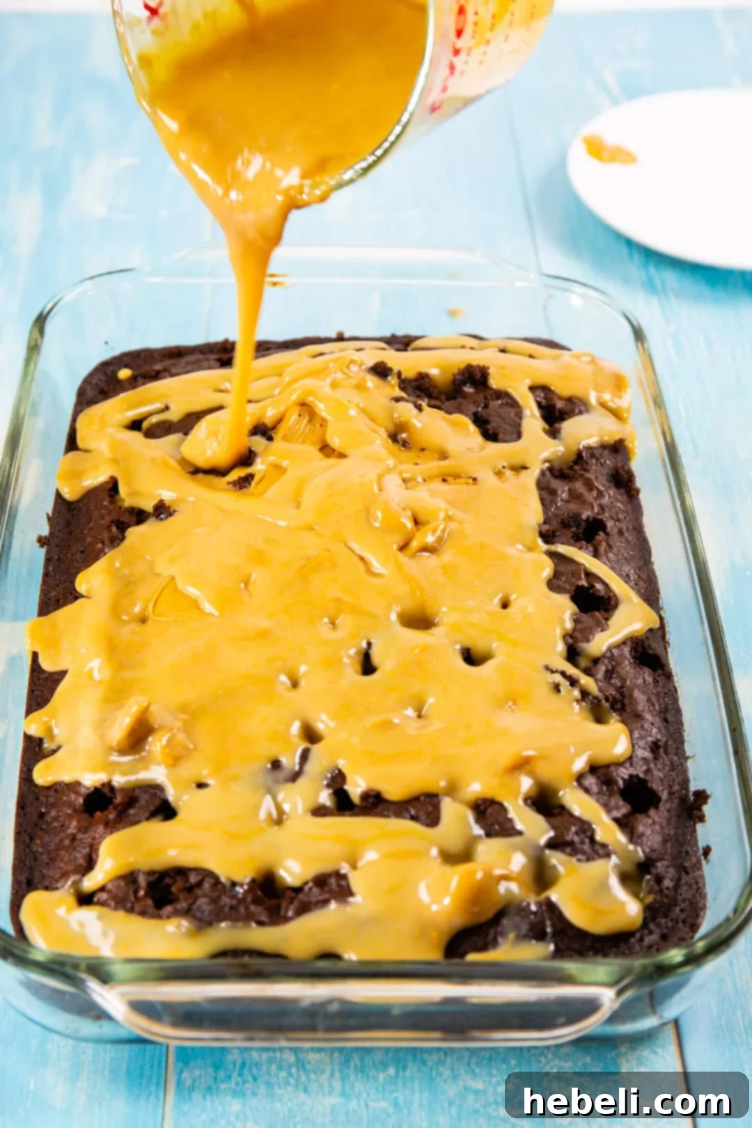 Filling being poured over cake.