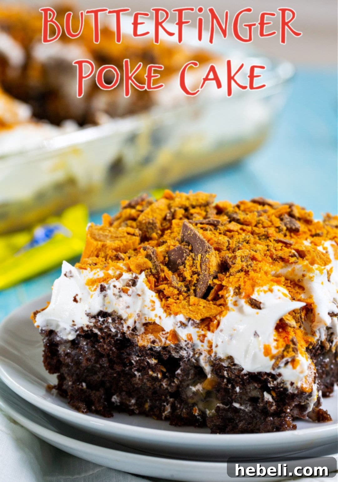 Piece of Butterfinger Poke Cake on a plate.