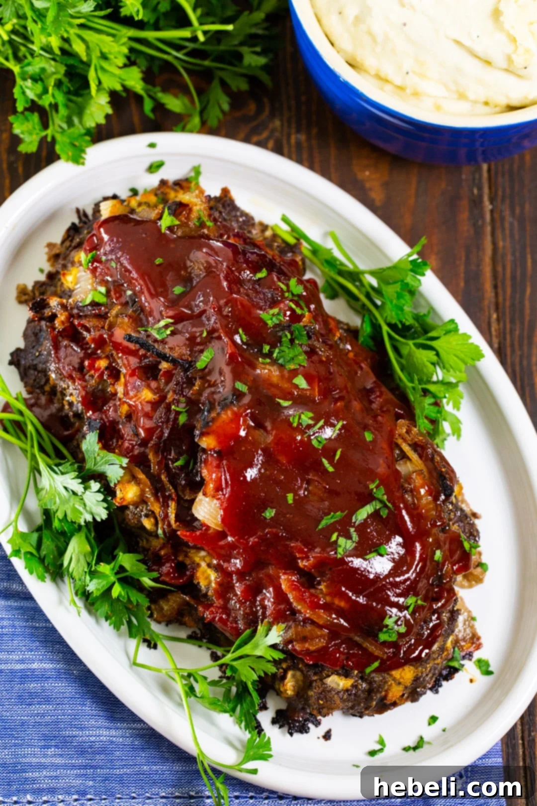 Sweet & Savory Caramelized Onion Meatloaf 3 Caramelized Onion Meatloaf on serving platter with parsley, showcasing its rich topping.