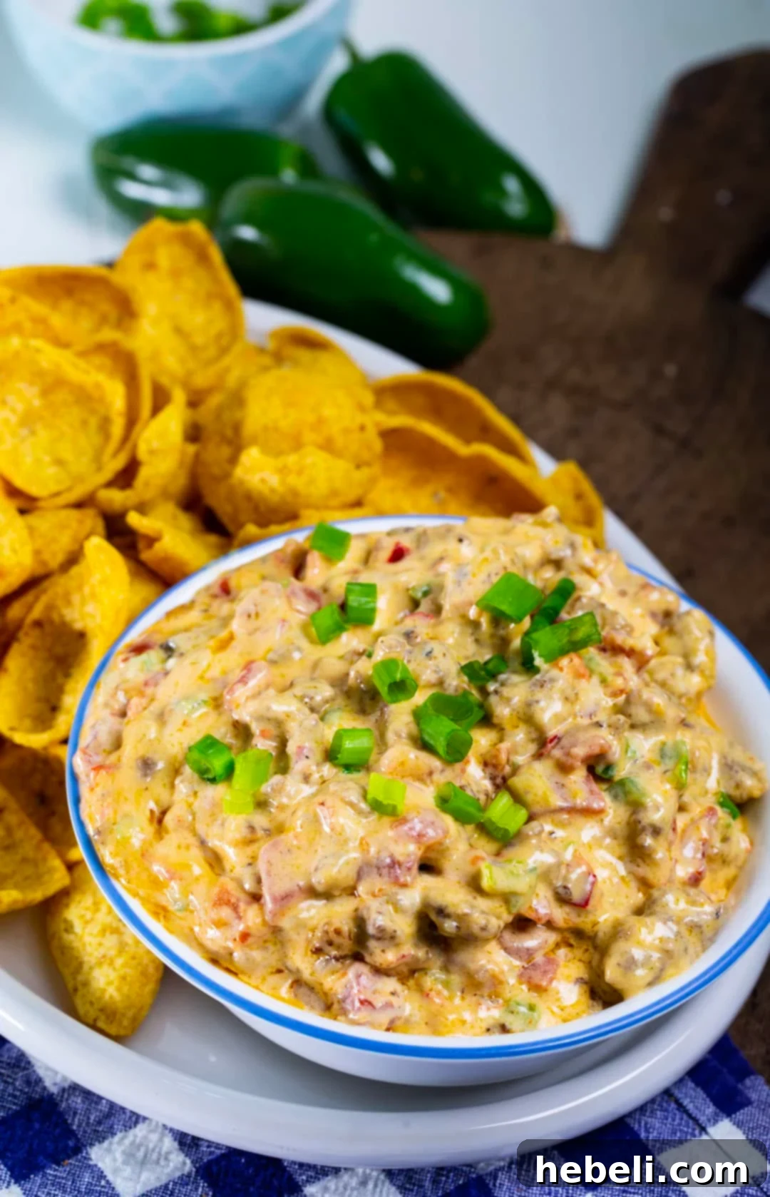 Savory Sausage Pimento Cheese Dip 4 Sausage Pimento Cheese Dip in a serving bowl, surrounded by crispy corn chips.