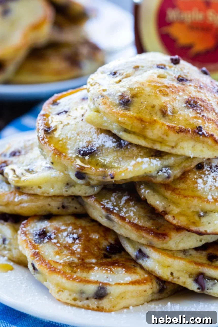 Tangy Mini Chocolate Chip Pancakes 4 A close-up shot of a stack of fluffy Sour Cream Mini Chip Pancakes, highlighting their texture and chocolate chips.