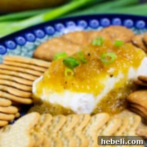 Jezebel Sauce in a serving bowl with a spoon