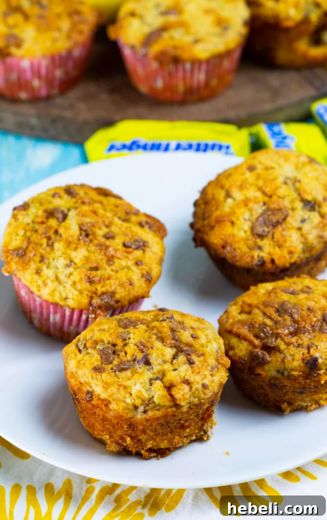 A trio of delicious Butterfinger Banana Muffins on a white plate, ready to be enjoyed.