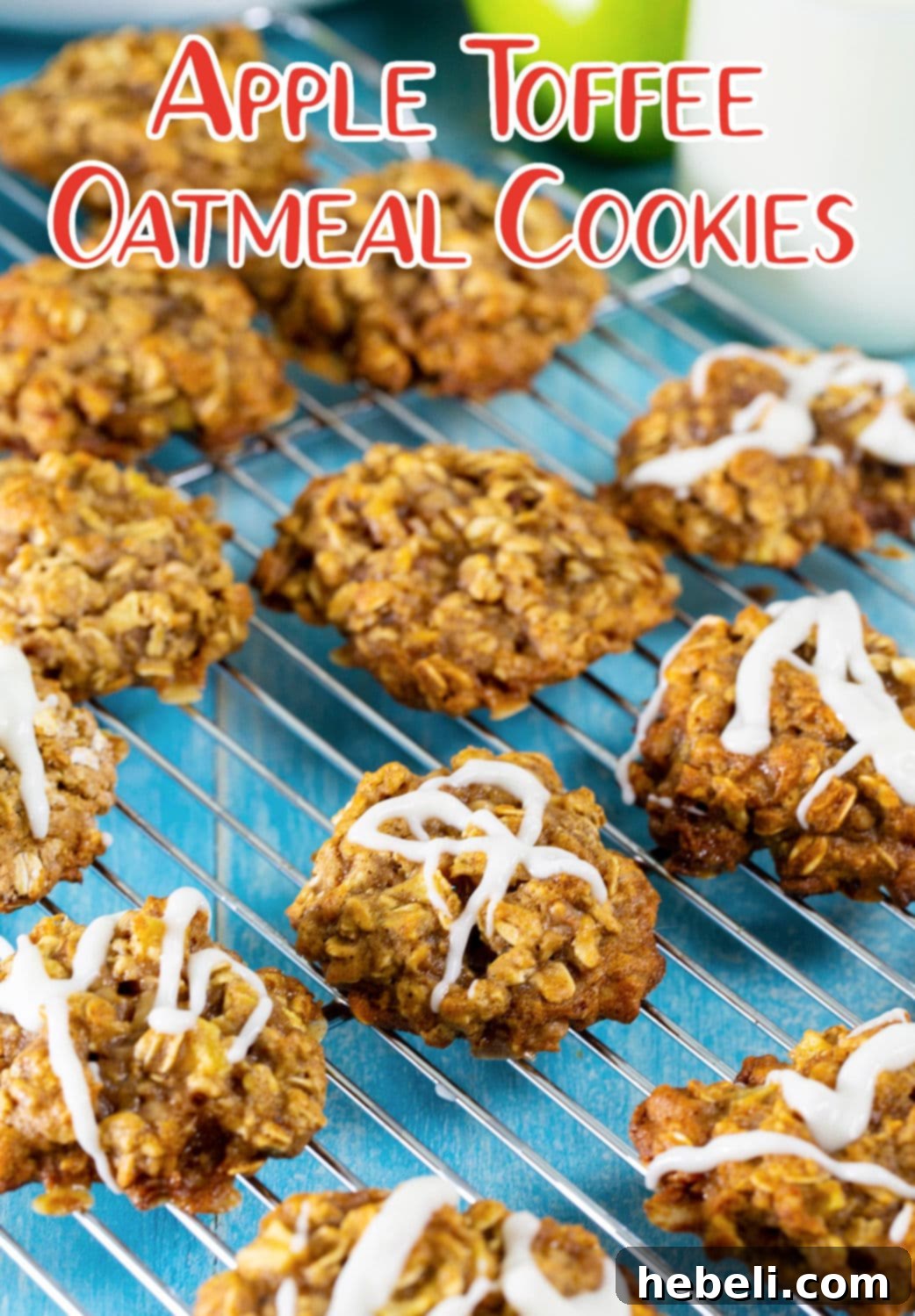 A batch of freshly baked Apple Toffee Oatmeal Cookies cooling on a wire rack.