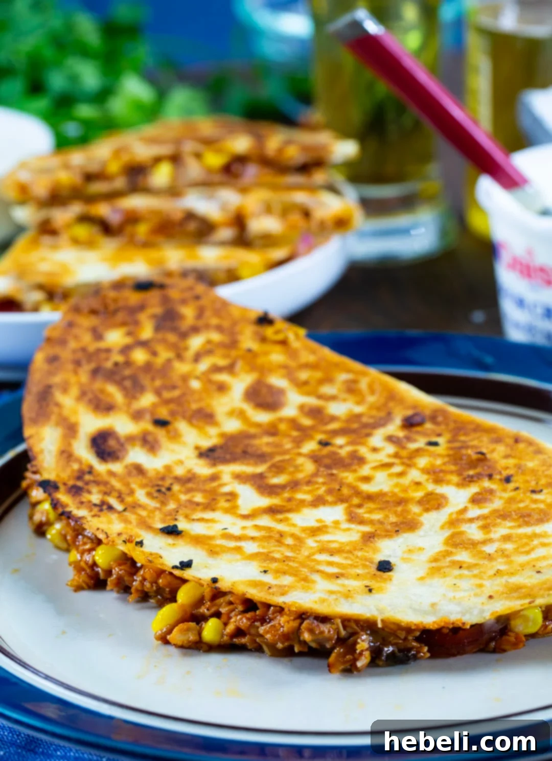 Loaded BBQ Chicken Quesadillas 3 A vibrant, whole BBQ Chicken Quesadilla served elegantly on a plate, showcasing its golden-brown tortilla.