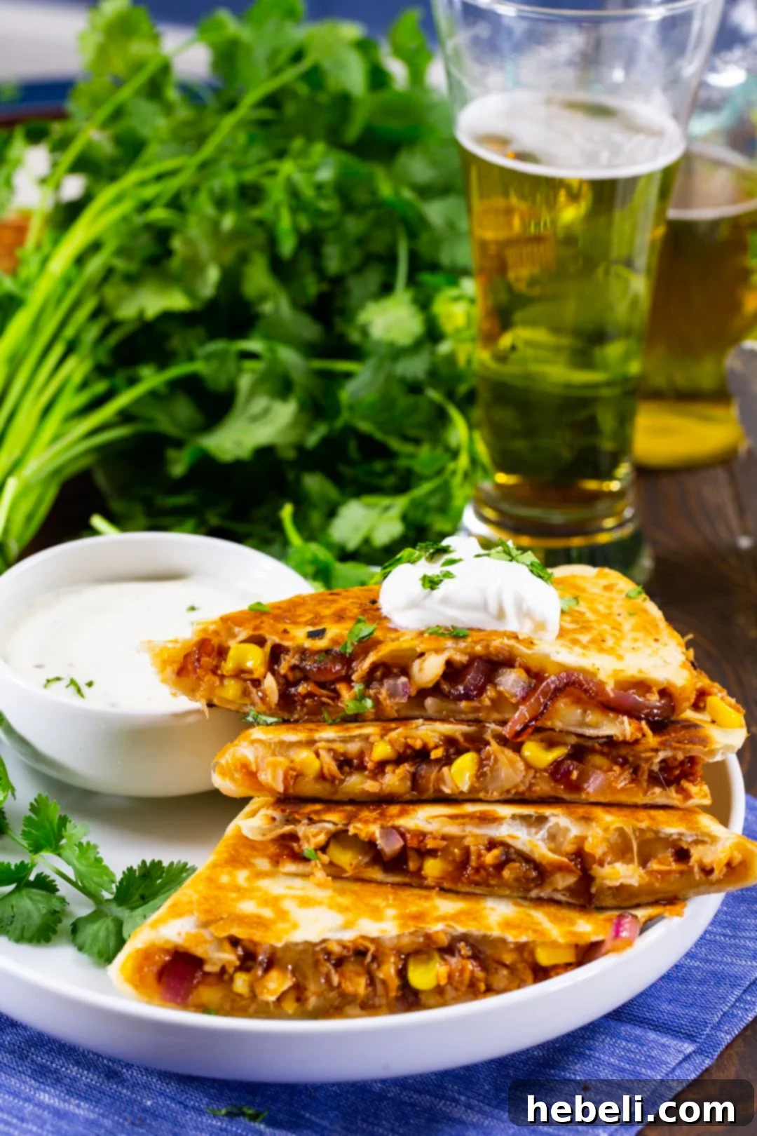 Loaded BBQ Chicken Quesadillas 4 A perfectly cooked BBQ Chicken Quesadilla alongside a refreshing glass of beer, highlighting a casual meal setting.
