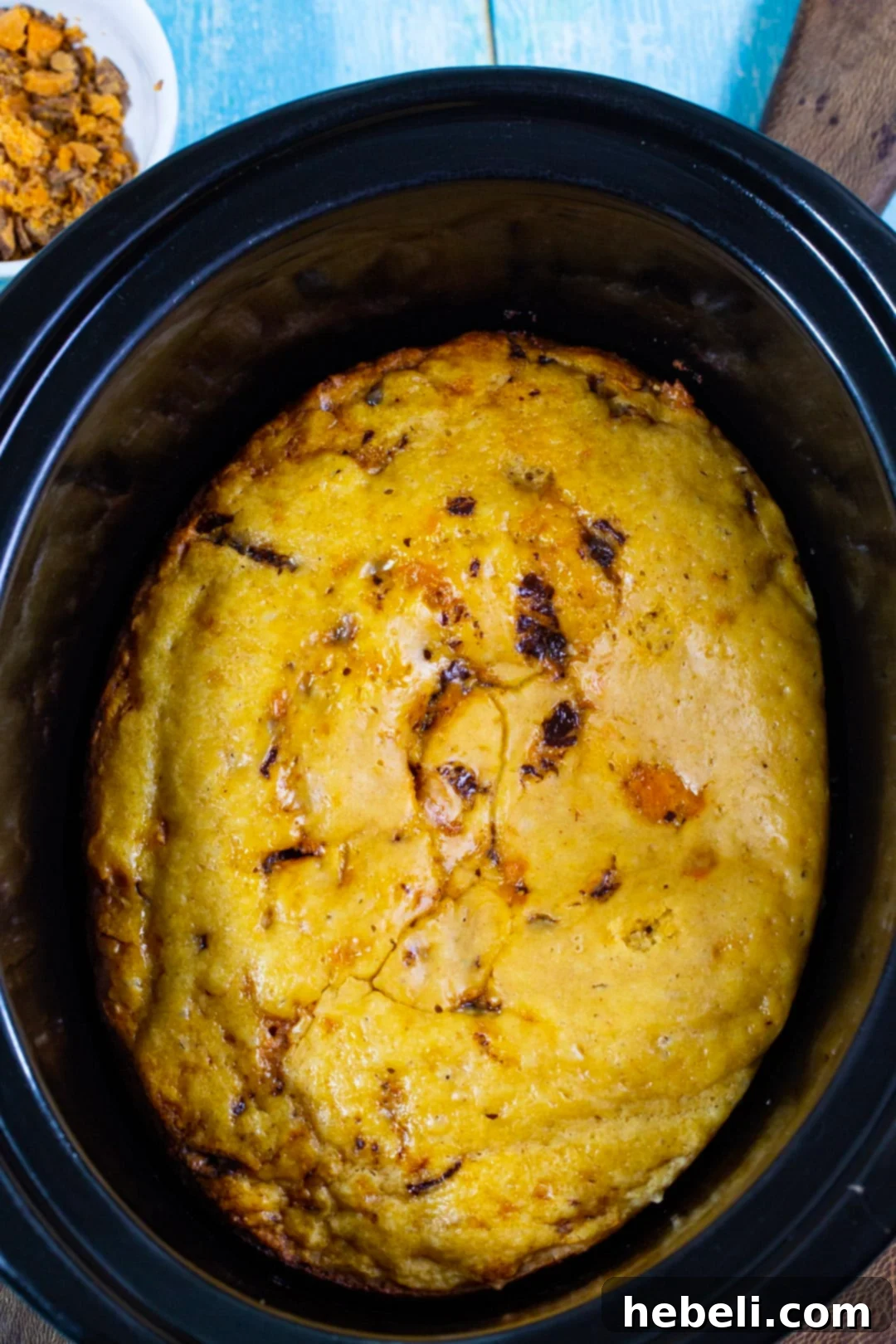 Crock Pot Butterfinger Cake 3 Unfrosted yellow cake baking in a slow cooker.