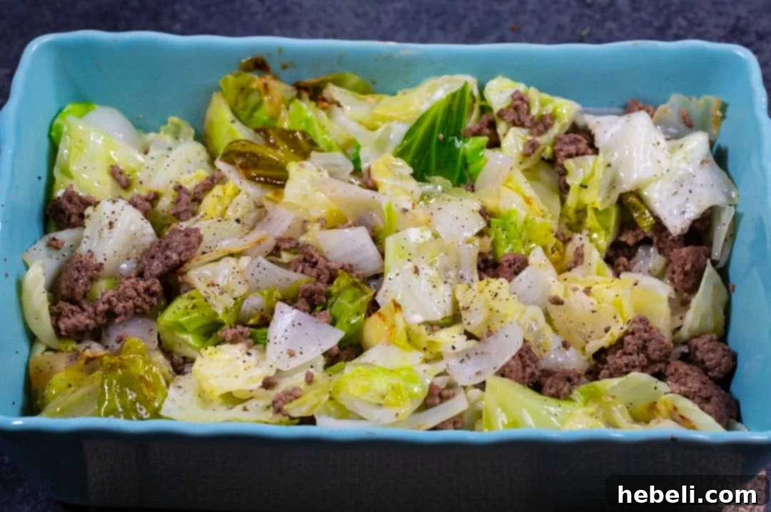 Comforting Beef and Cabbage Casserole 3 Close-up of the Cabbage Ground Beef mixture settling in a baking dish before the sauce and topping are added.