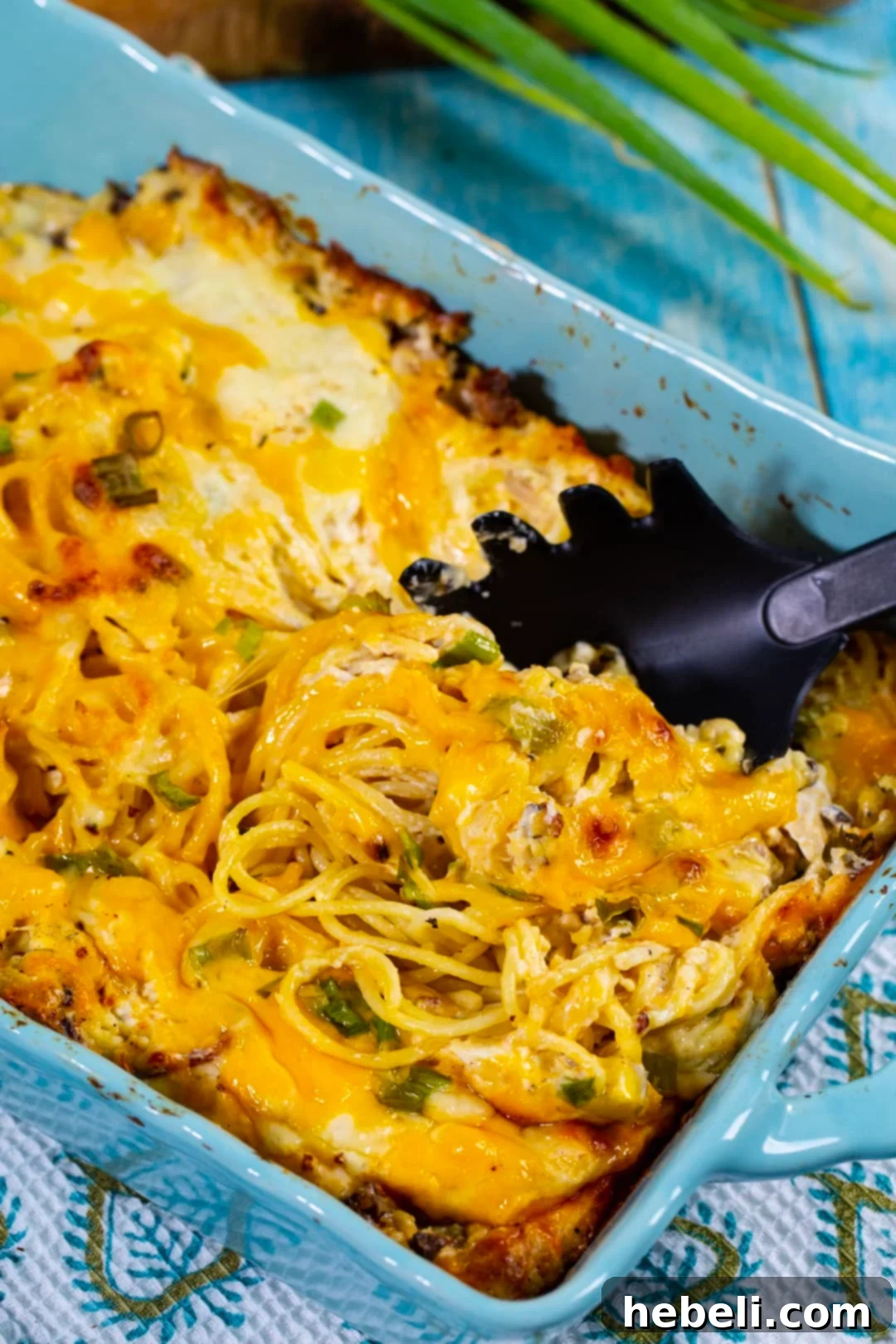 Close-up of Crack Chicken Spaghetti in a casserole dish, showing the rich, creamy sauce and melted cheese.