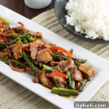 Savory Garlic Pork Stir-Fry 3 Close-up of vibrant Pork and Asparagus Stir-Fry in a pan, showcasing fresh ingredients.