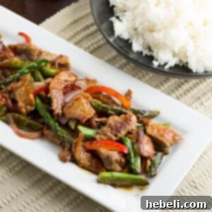 Savory Garlic Pork Stir-Fry 4 Pork and Garlic Stir-Fry, served hot with a side of rice.