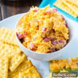 Pimento Cheese in a bowl surrounded by crackers, a delicious and easy dip.