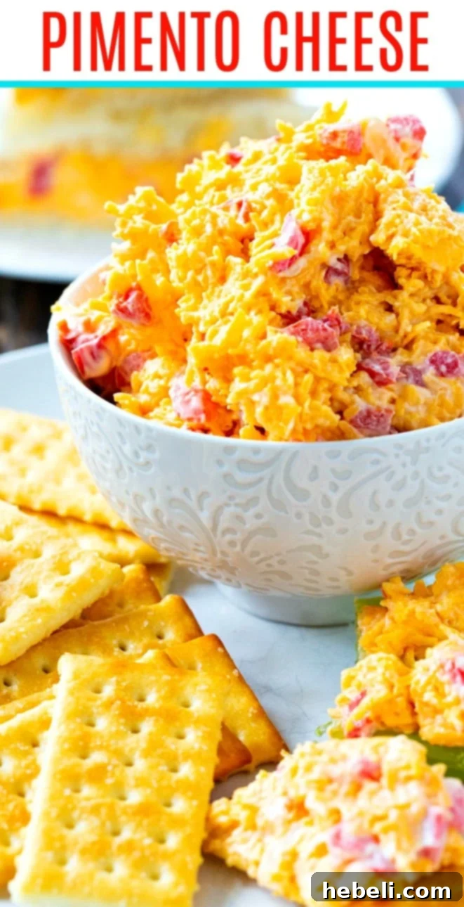 Southern Pimento Cheese Perfection 6 Close-up of creamy pimento cheese with crispy crackers, illustrating its irresistible texture and vibrant color.