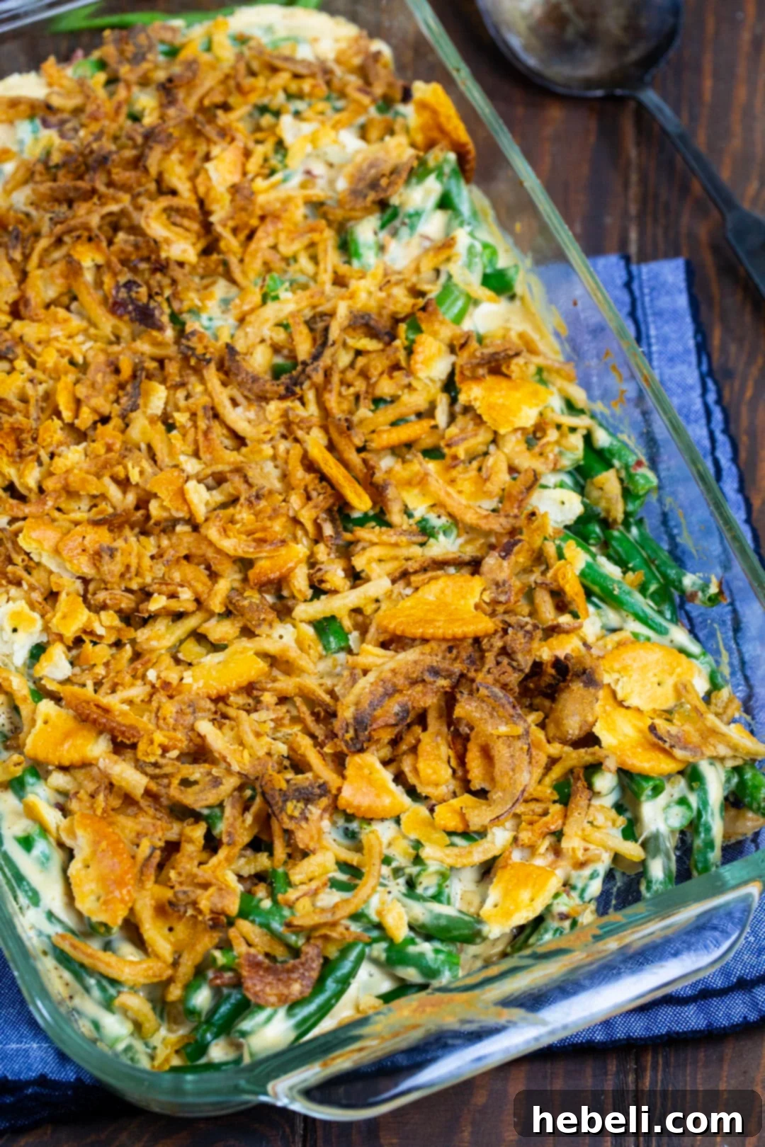 Cream Cheese Green Bean Casserole topped with French-fried onions and Ritz Cracker crumbs.