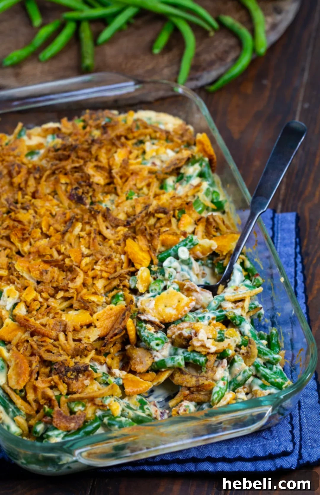 Spoon scooping casserole out of baking dish.