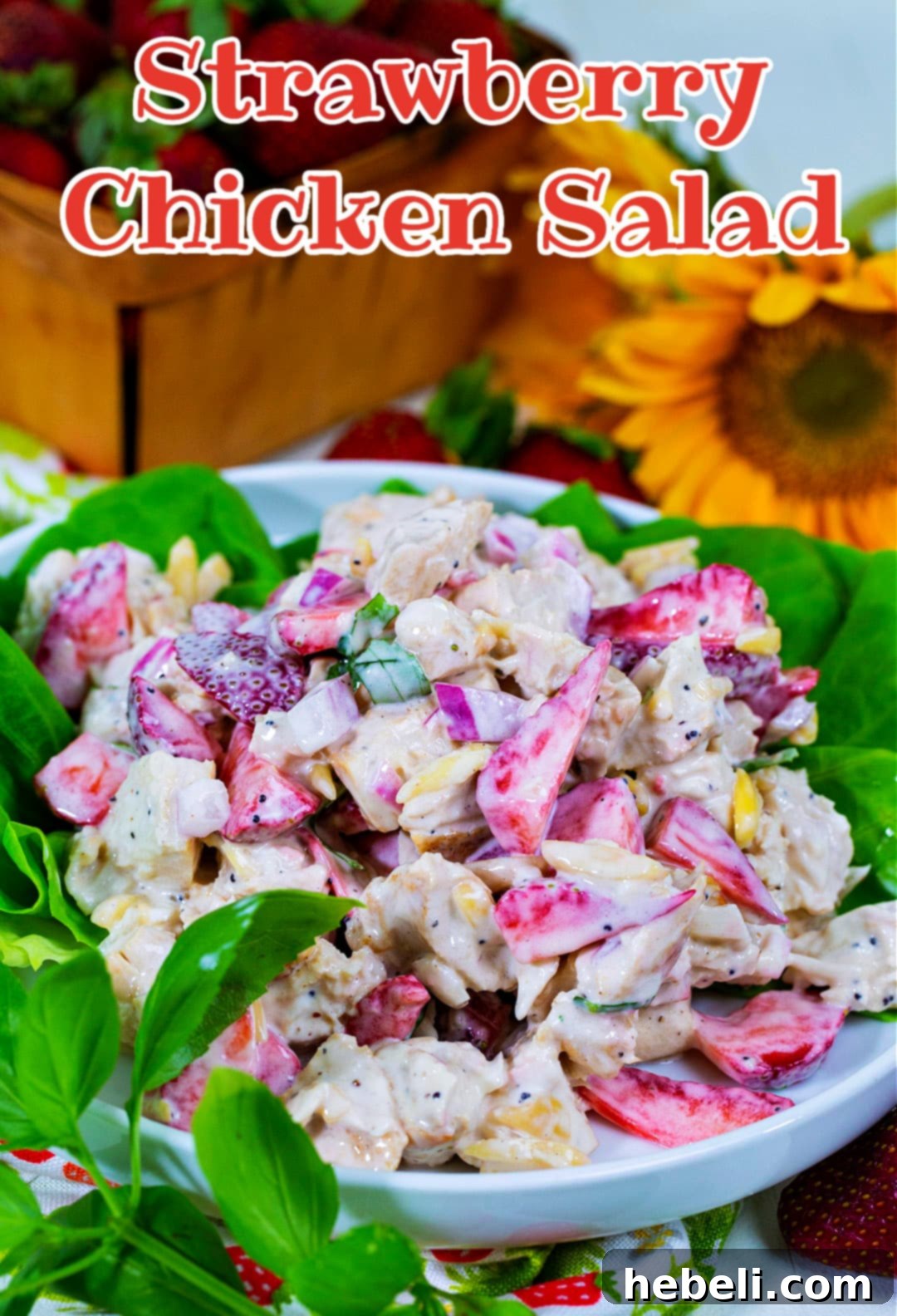 A final presentation of Strawberry Chicken Salad with fresh strawberries and basil garnish.