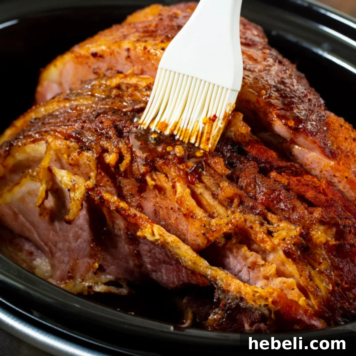 Slow Cooker Hot Honey Glazed Ham 2 Hot Honey Ham in a slow cooker, featuring its rich, glossy glaze.