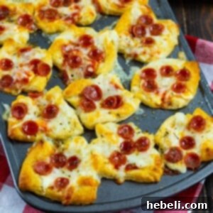 Cheesy Pepperoni Pizza Bites 7 A serving of finished Pepperoni Pizza Poppers, golden brown with melted cheese and pepperoni.