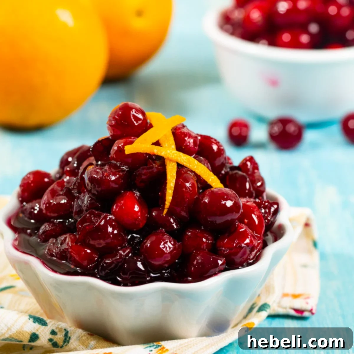 Homemade Slow Cooker Cranberry Sauce 2 A bowl of vibrant Slow Cooker Cranberry Sauce, ready to be served for the holidays.