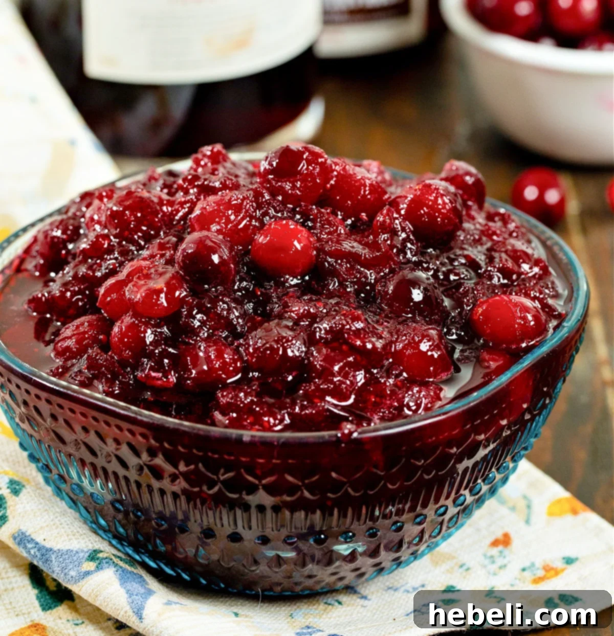 Cranberry Bourbon Relish 2 A serving bowl filled with glossy, deep red Boozy Cranberry Sauce, ready to be enjoyed as a holiday side dish.