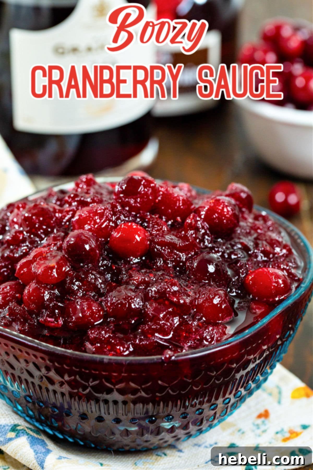 Cranberry Bourbon Relish 5 Close-up of Boozy Cranberry Sauce in an elegant serving bowl, garnished with a few fresh cranberries and an orange twist.