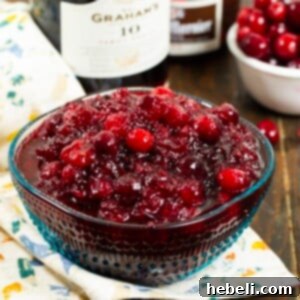 Delicious Boozy Cranberry Sauce in a small white serving bowl.
