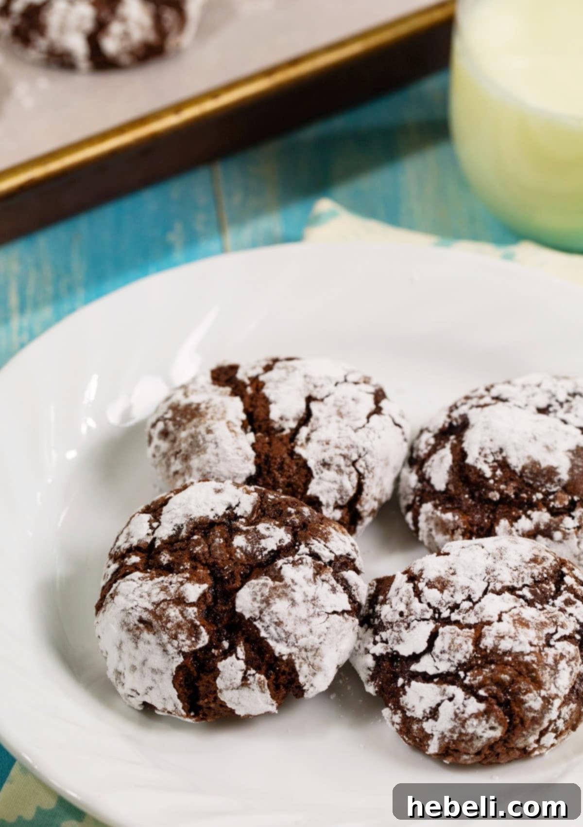 Stacked Chocolate Peppermint Crinkle Cookies on a white plate, ready for serving or gifting.