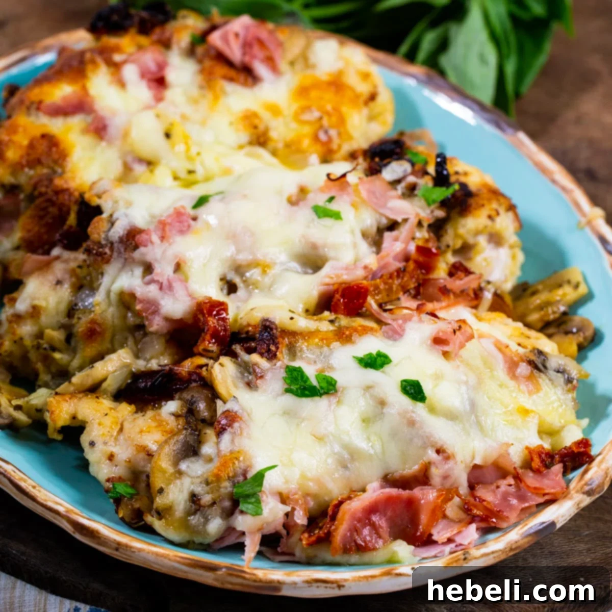 The Company Coop 2 Company Chicken on a serving platter, showcasing the rich topping and melted cheese.