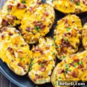 Stuffed Potatoes arranged close together on a baking sheet, showcasing their golden topping.