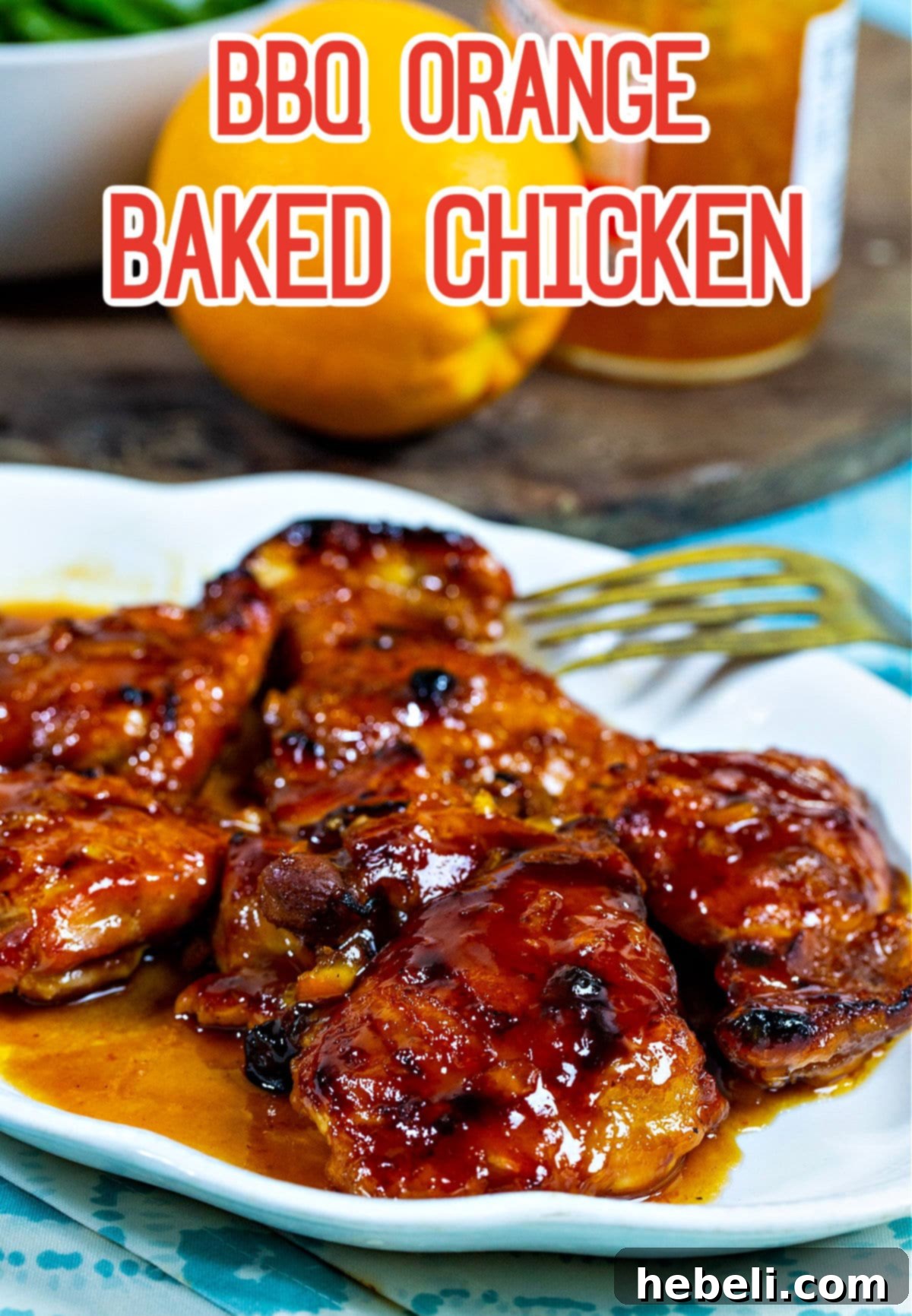 A large serving platter presenting slices of succulent BBQ Orange Baked Chicken, ready to be enjoyed with accompanying sides.