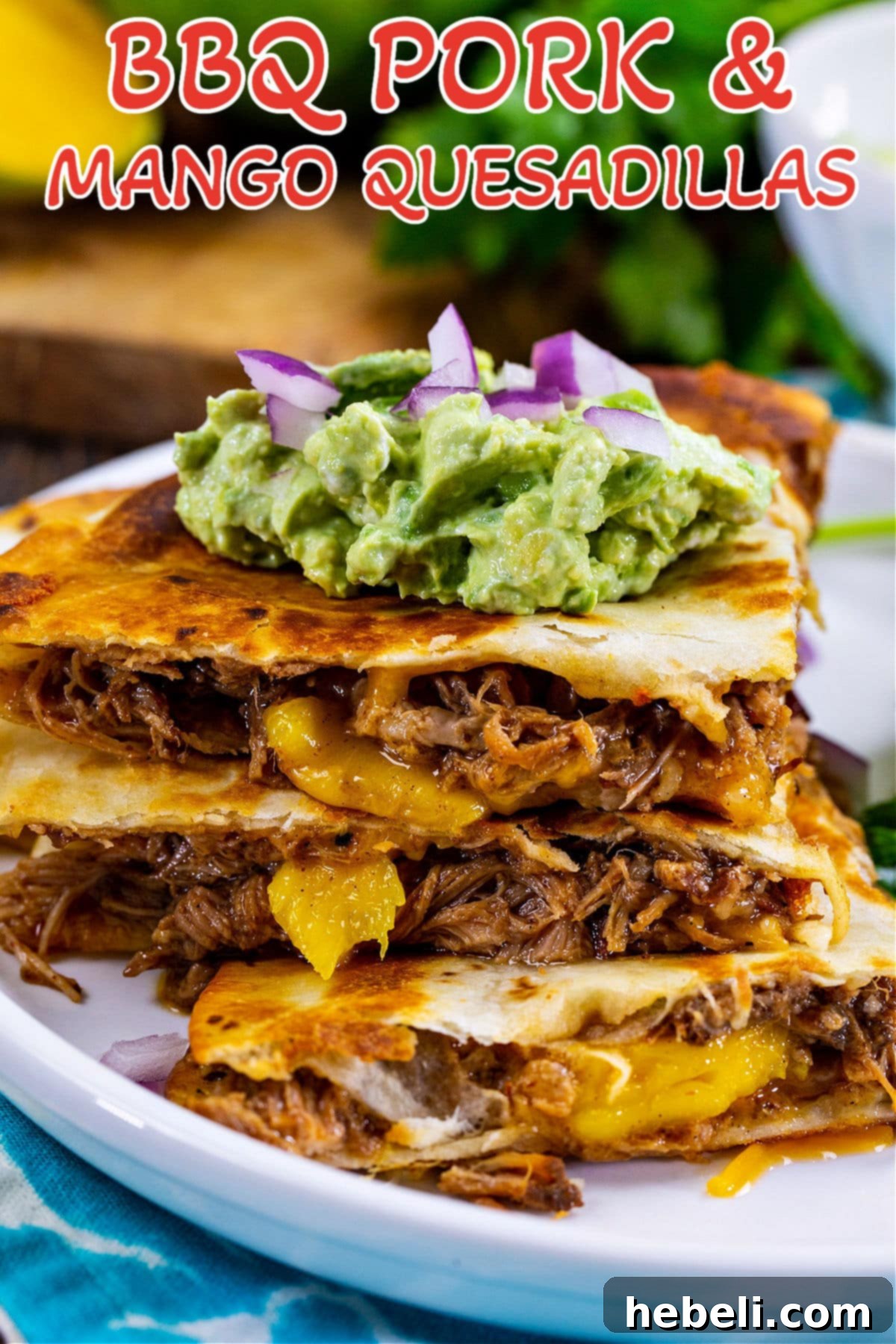 Island BBQ Pork and Mango Quesadillas 7 A single BBQ Pork and Mango Quesadilla triangle on a plate with fresh cilantro garnish.