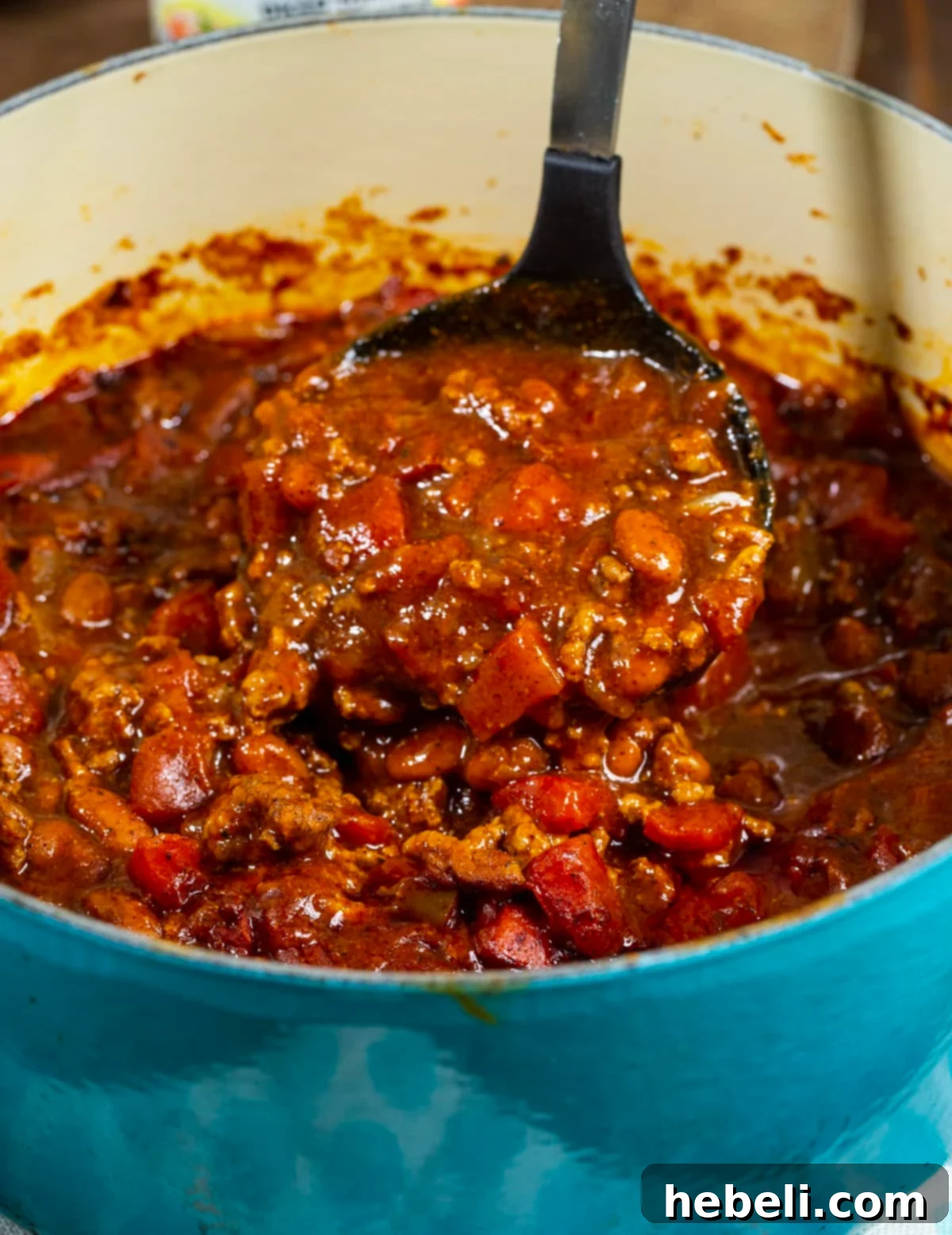 Ultimate Rotel Chili 4 A ladle scooping up a hearty portion of Rotel Chili from a pot.