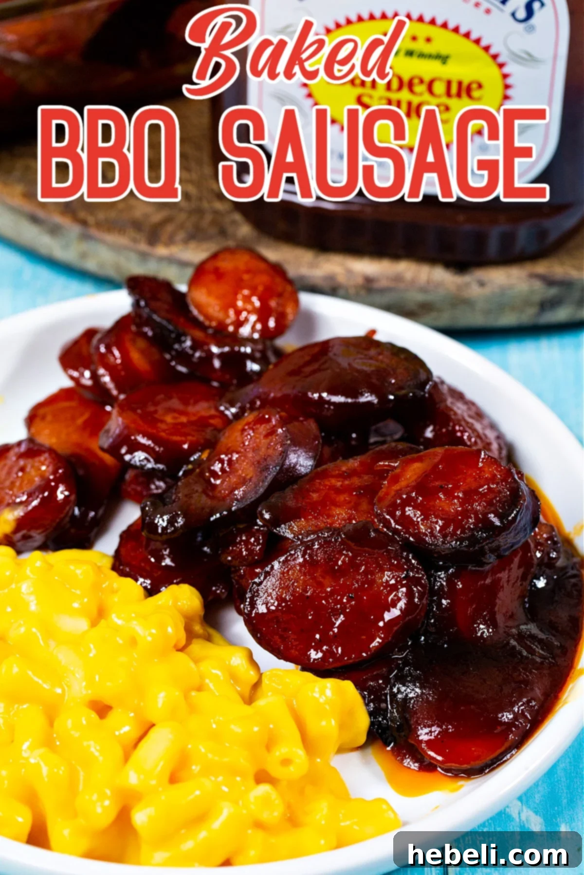 Baked BBQ Sausage served on a plate with a side of creamy mac and cheese, showcasing a complete meal.