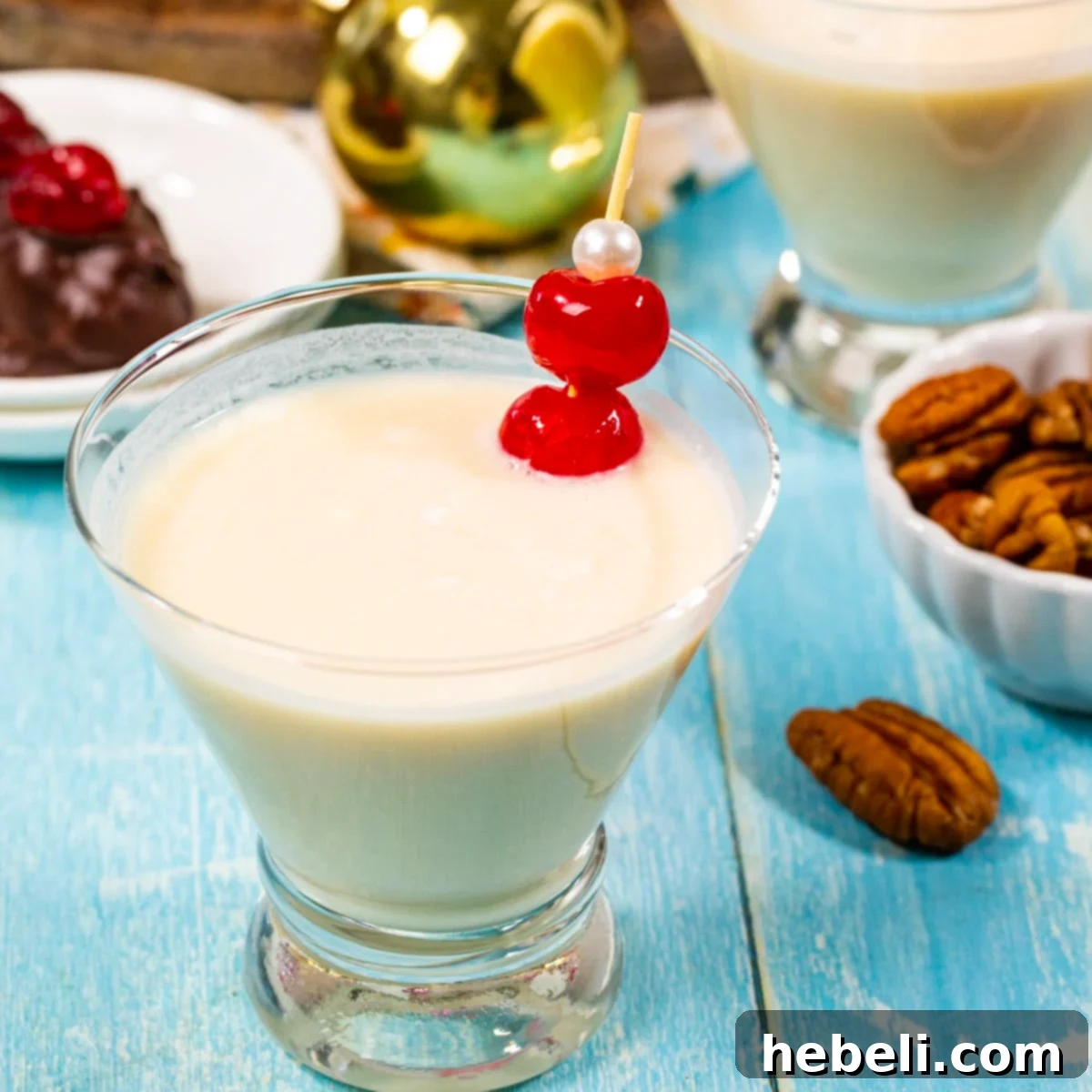A beautifully presented Bourbon Ball Cocktail in a martini glass, garnished with vibrant maraschino cherries, promising a luxurious sip.