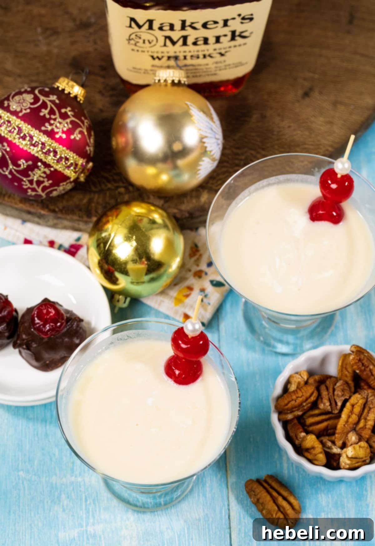 Two Bourbon Ball Cocktails served in elegant glasses, accompanied by a plate of homemade bourbon balls, ready for a festive celebration.
