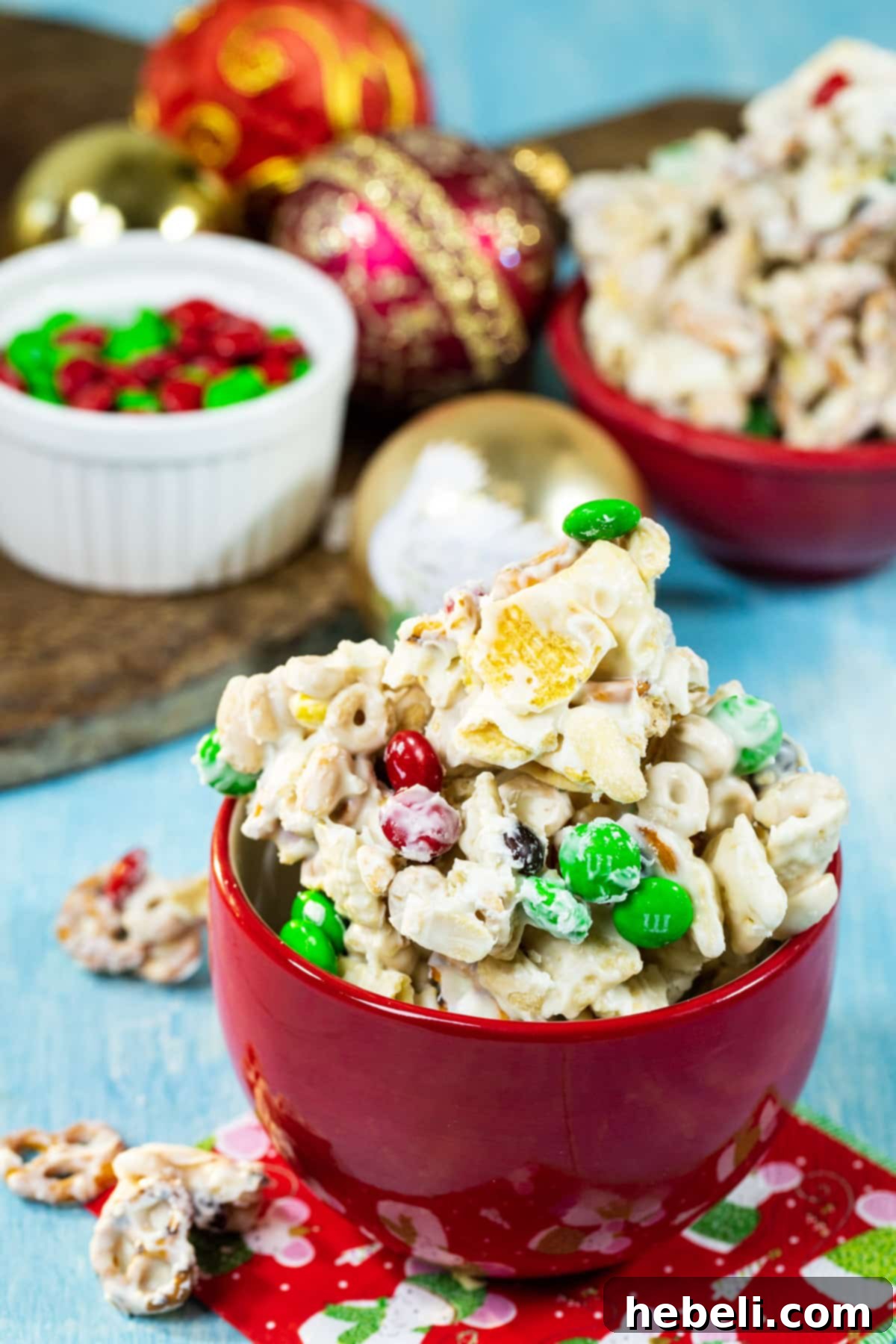 Close-up of white chocolate-coated cereal and pretzels on a baking sheet.