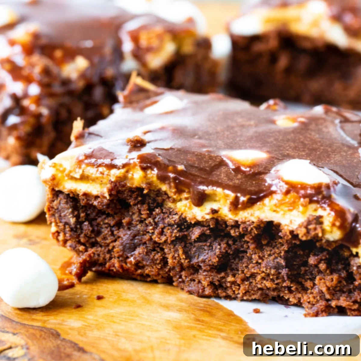 Peanut Butter Mississippi Mud Brownies on a cutting board, showcasing their layers of chocolate, marshmallow, and peanut butter.