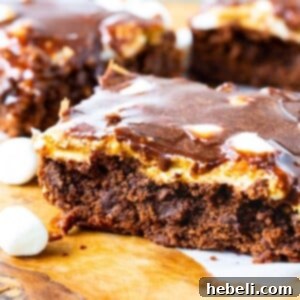 Peanut Butter Mississippi Mud Brownies on a cutting board, showing a slice.