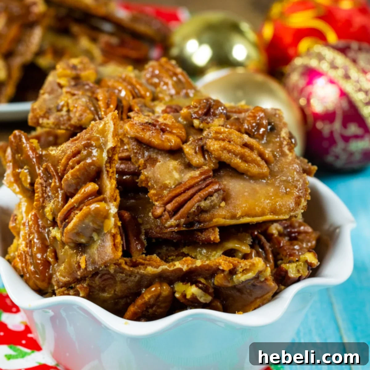 Pecan Pie Bark in a festive serving dish, showcasing its golden caramel and pecan topping.