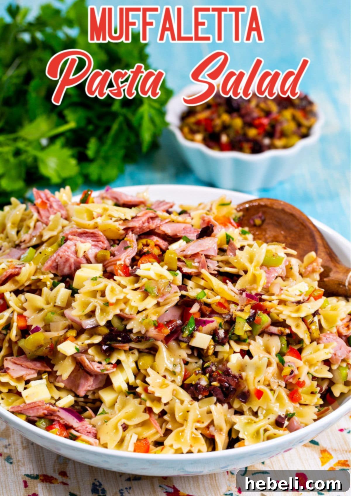 Zesty Muffaletta Pasta Salad 4 A large serving bowl filled with colorful Muffaletta Pasta Salad, ready to be enjoyed.