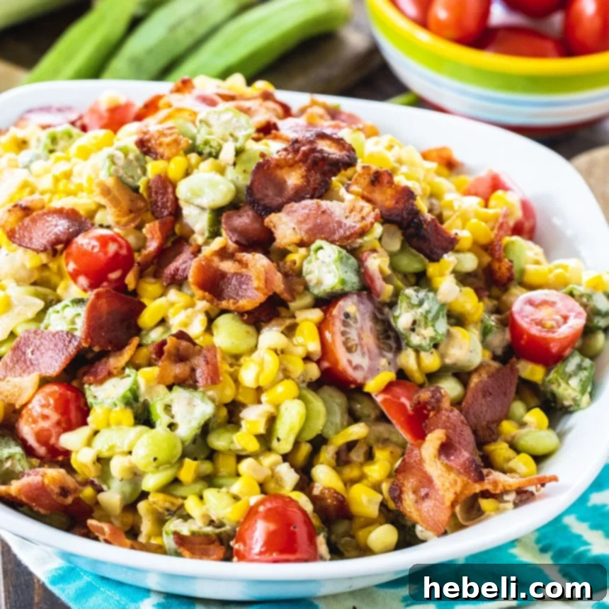 A beautifully presented bowl of Summer Succotash, showcasing vibrant corn, tender green lima beans, and crispy bacon bits on top.