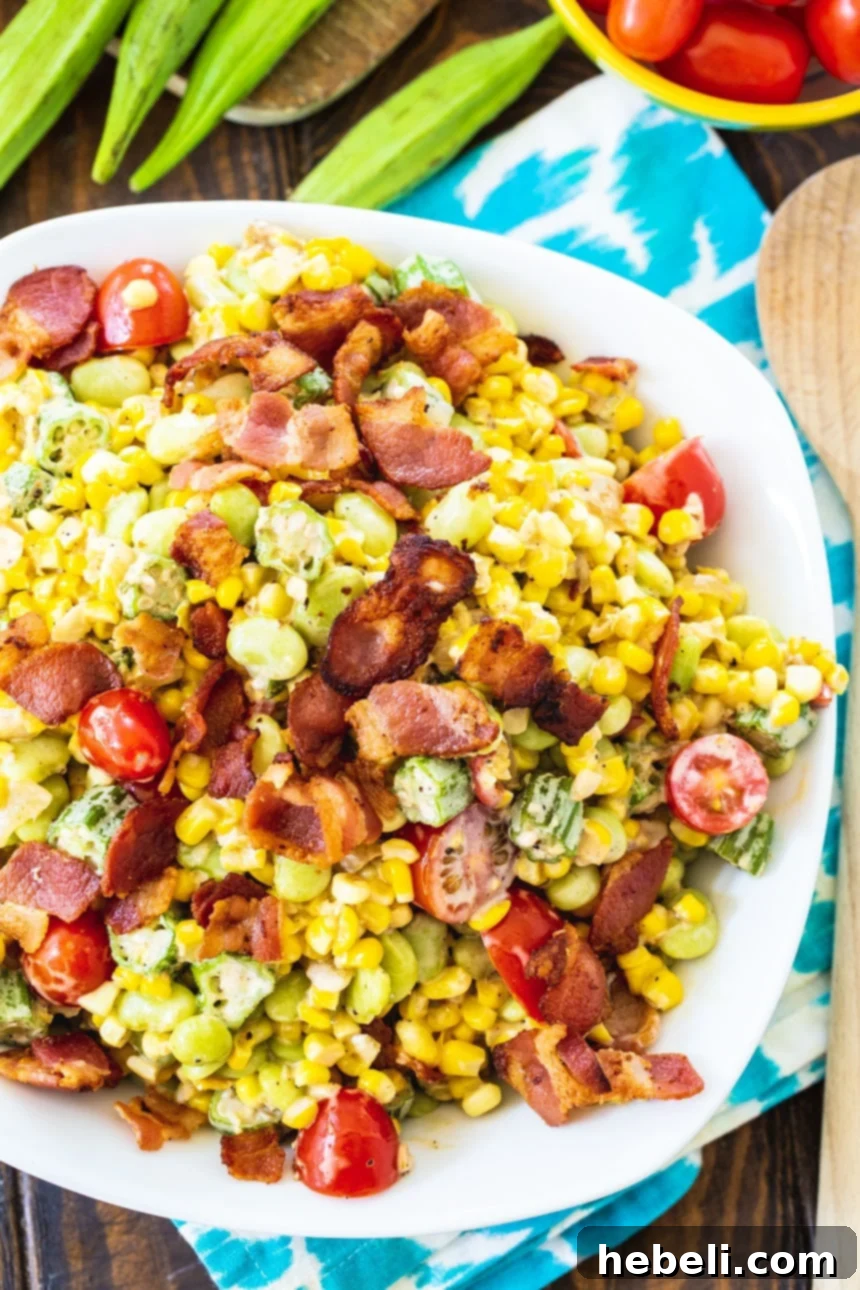 An overhead shot of Southern Succotash in an elegant white serving bowl, garnished and ready for a meal.