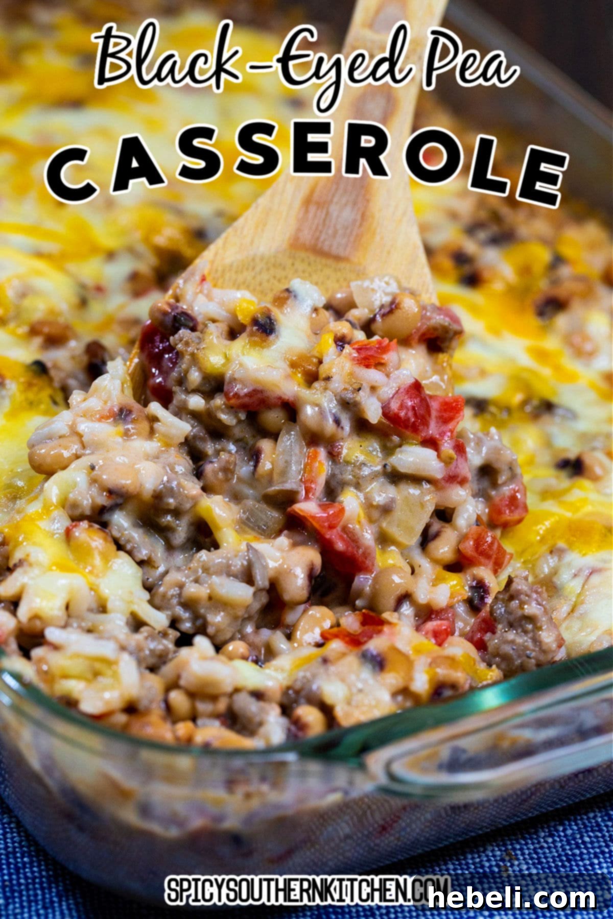Southern Comfort Pea Bake 5 A spoonful of cheesy Black-Eyed Pea Casserole being scooped from the dish, highlighting its rich texture and melted cheese.