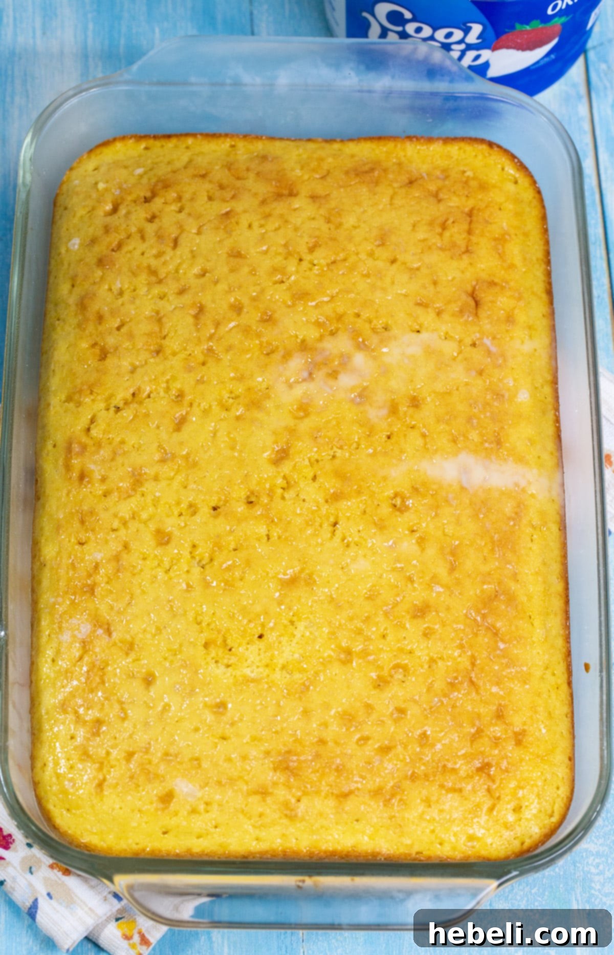 Effortless Tres Leches Cake 4 A freshly baked, unfrosted yellow cake resting in a 9x13-inch baking pan, ready to be soaked in the three-milk mixture.
